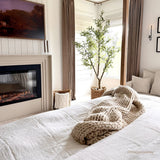 Touchstone Fireplug PRO electric fireplace insert installed in a bedroom