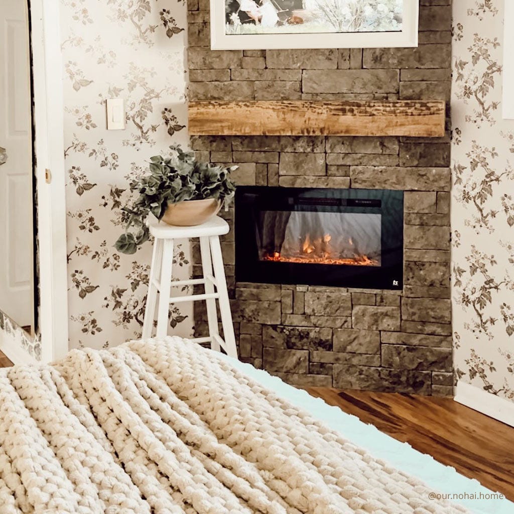 Touchstone Sideline 28-Inch recessed electric fireplace installed in a room