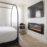 Touchstone Sideline 60 electric fireplace in a bedroom below a wall mounted TV