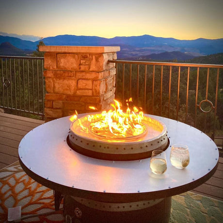 enjoying a glass of white wine by the wine barrel dude coffee table gas fire pit table
