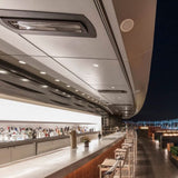 Black bromic tungsten smart-heat black electric patio heater flush mounted at a bar outdoors