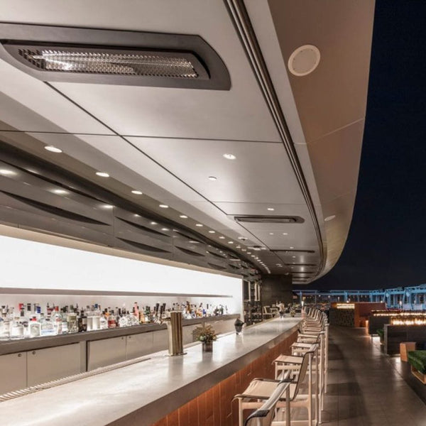 Black bromic tungsten smart-heat black electric patio heater flush mounted at a bar outdoors