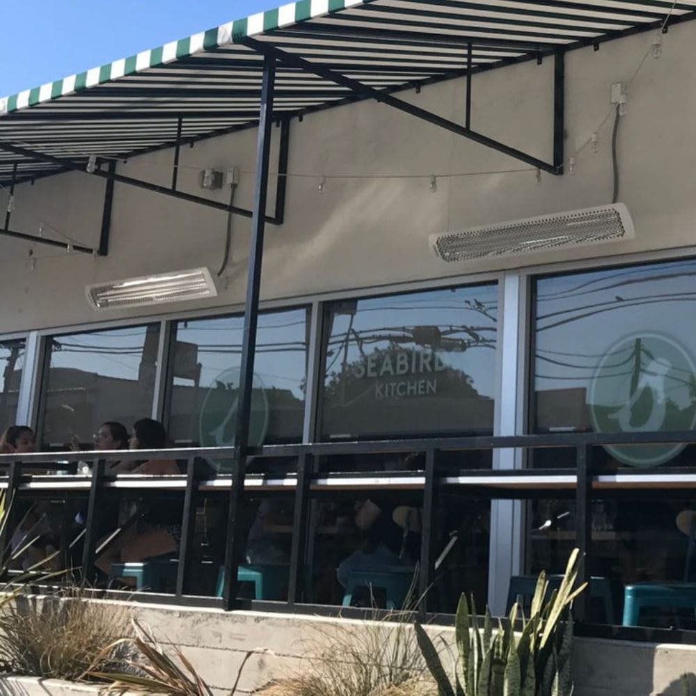 White bromic tungsten smart-heat electric patio heater in seabird kitchen restaurant, california