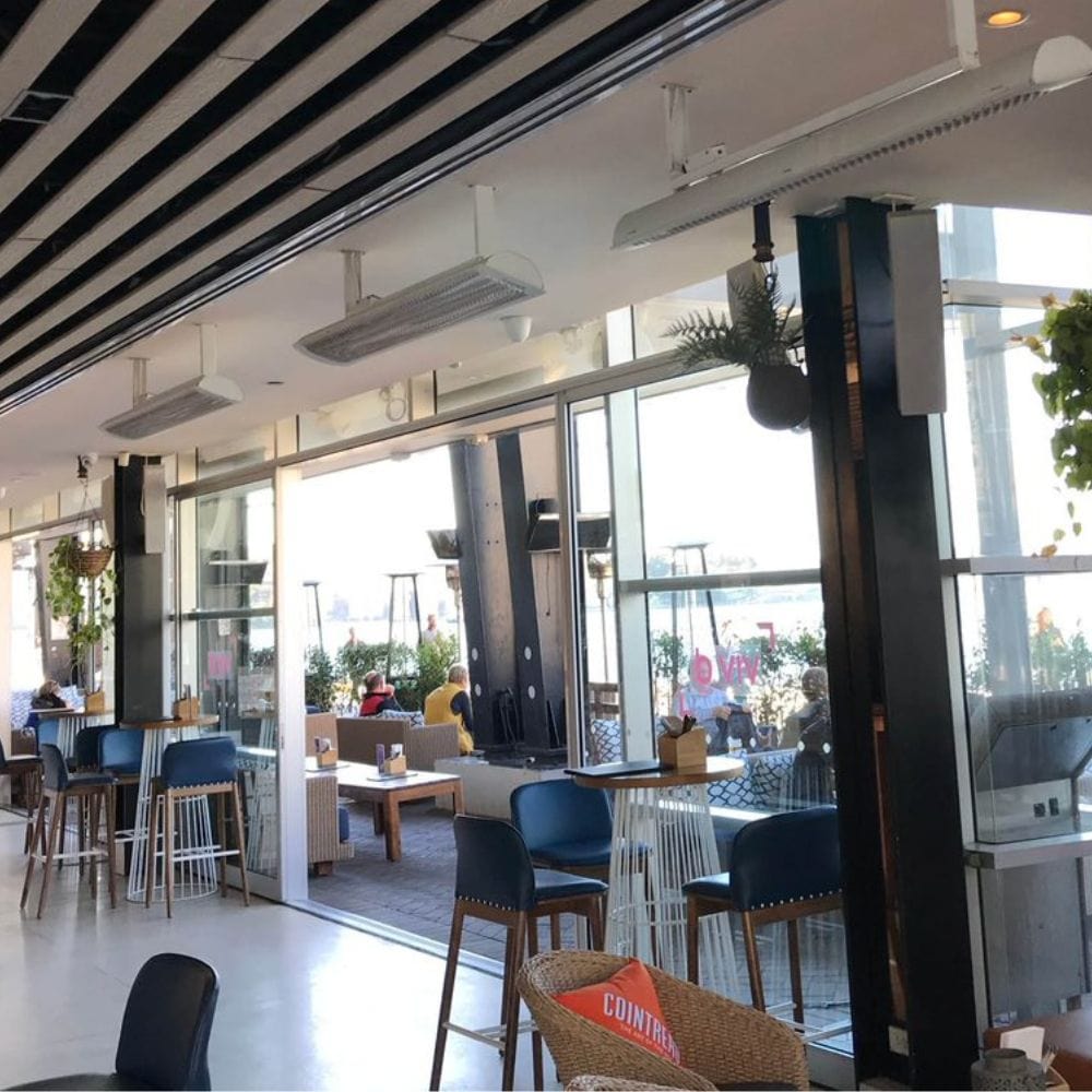 White bromic tungsten smart-heat electric patio heater indoors in a restaurant in australia