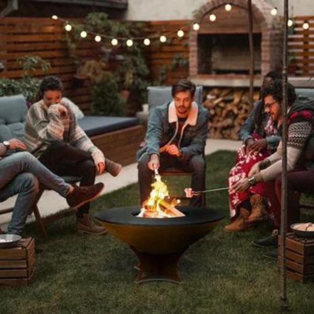 roasting marshmallows with friends on the arteflame low euro base fire pit