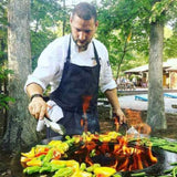 Grilling vegetables on the Arteflame 30" Tall Euro Base Corten Steel Fire Pit with Cooktop