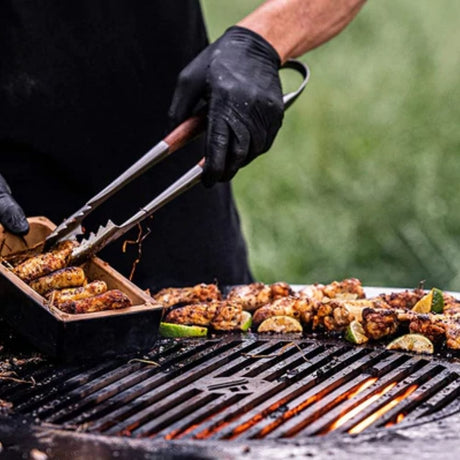 Cooking outdoors on Arteflame Classic 38-Inch Corten Steel Fire Pit with Storage