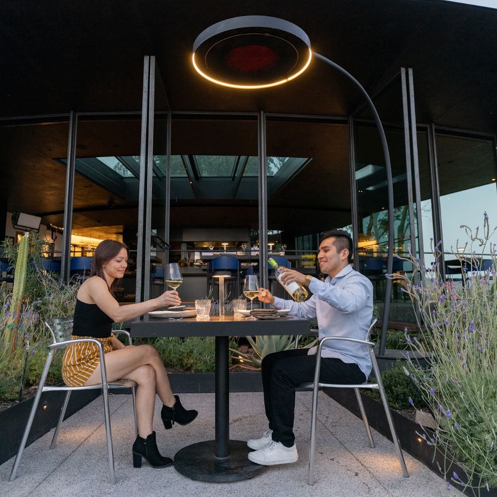 bromic eclipse smart-heat electric patio heater providing warmth to a lovely couple