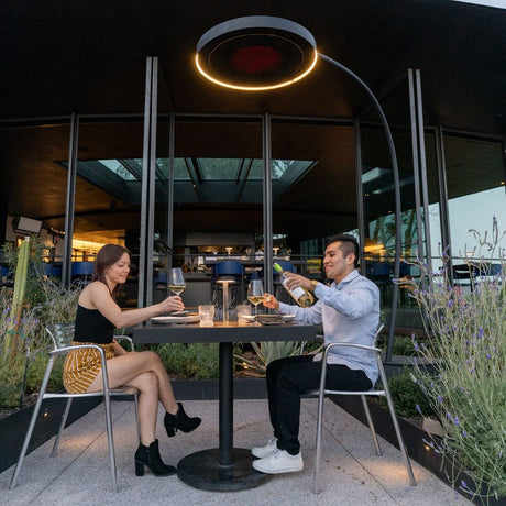 bromic eclipse smart-heat electric patio heater providing warmth to a lovely couple