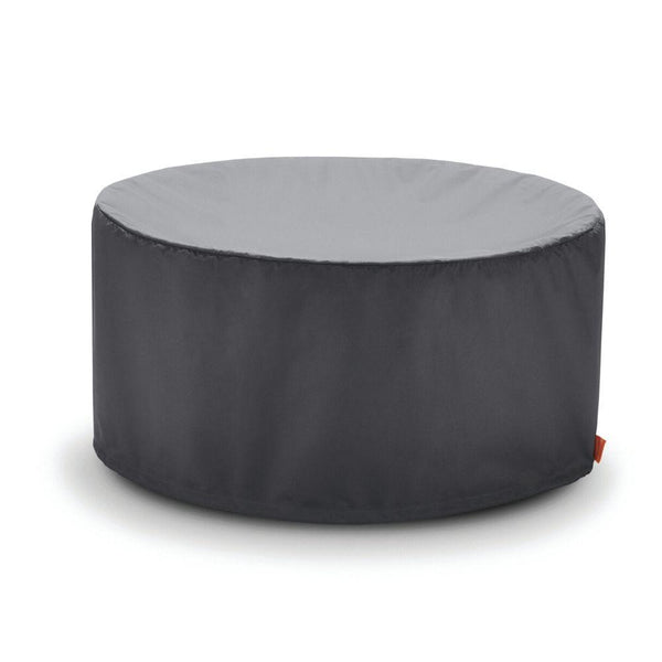 A round gray ottoman with a small orange tag on the side.