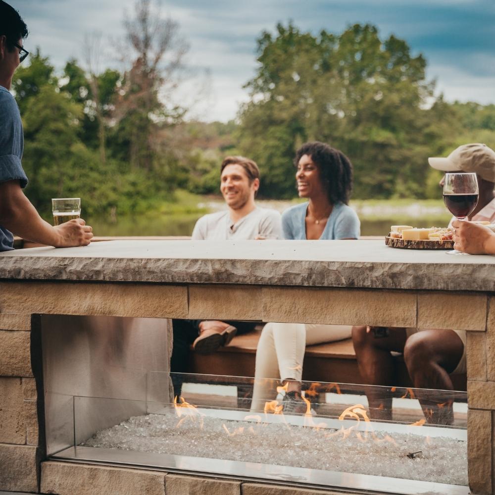 People Enjoying Drinks and Snacks by the See-Through Fireplace