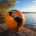 Fire Pit Art Third Rock - Globe Shaped 36" Handcrafted Carbon Steel Fire Pit (TR) Beside A Lake
