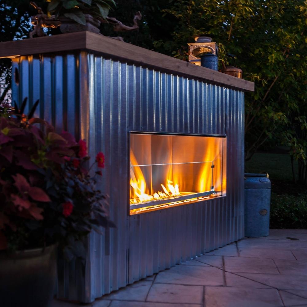 firegear kalea bay outdoor vent free gas fireplace in industrial outdoor setting