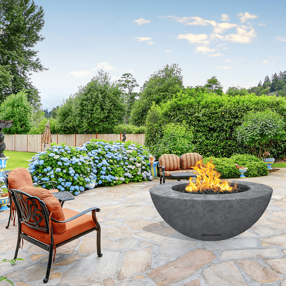 modern blaze round coal fire bowl with textured surface in a lush garden