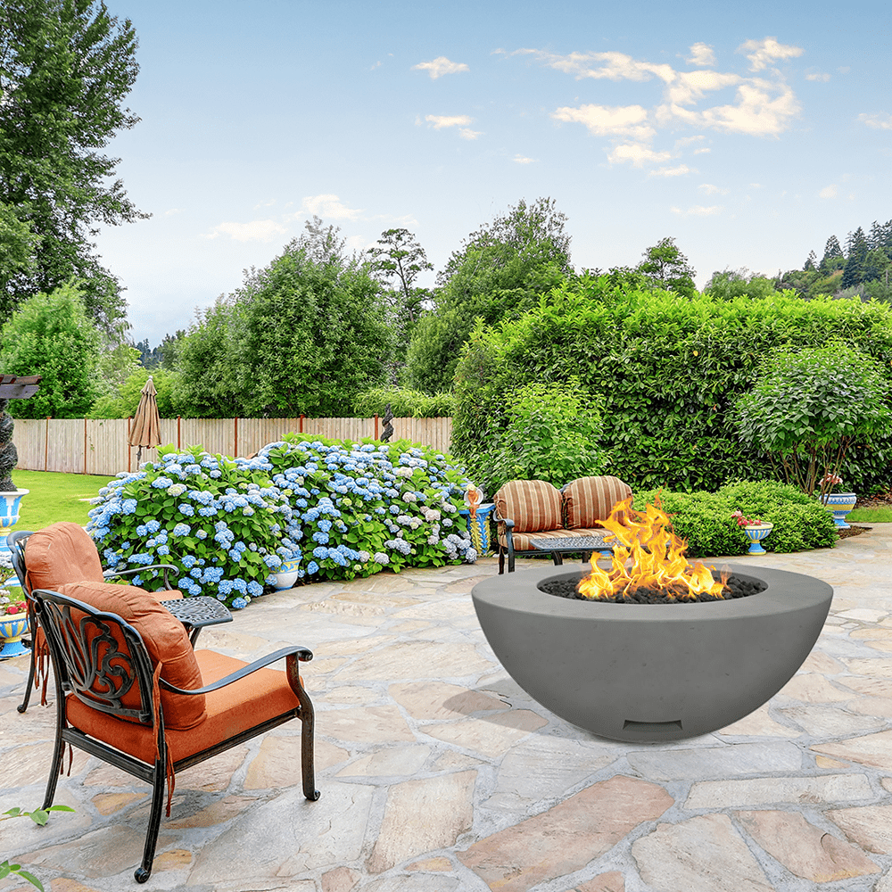 modern blaze round slate fire bowl with smooth surface in a lush garden
