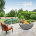 modern blaze round slate fire bowl with textured surface in a lush garden