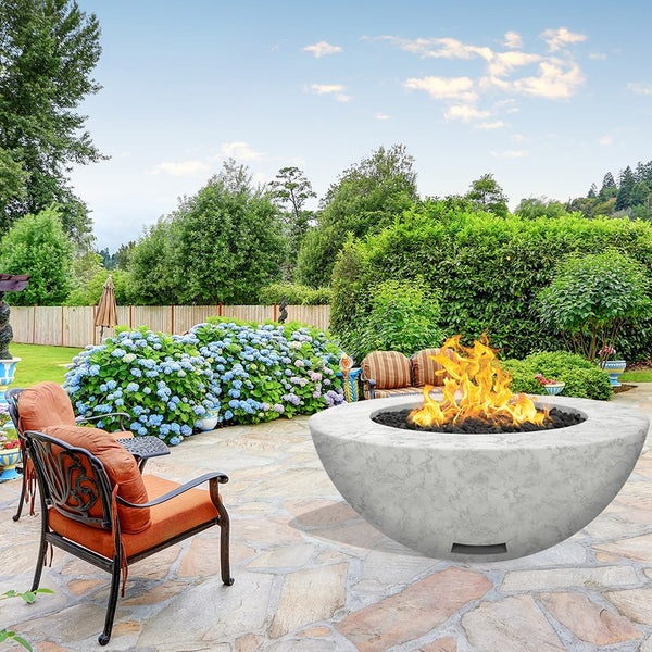 modern blaze round arctic fire bowl with textured surface in a lush garden - close-up view