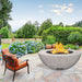 modern blaze round ivory fire bowl with textured surface in a lush garden