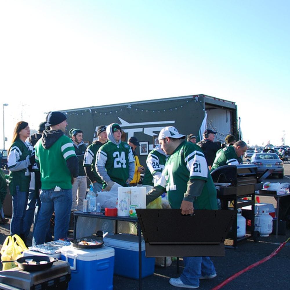 Man Holding Collapsed Fire Pit Tailgating with Team