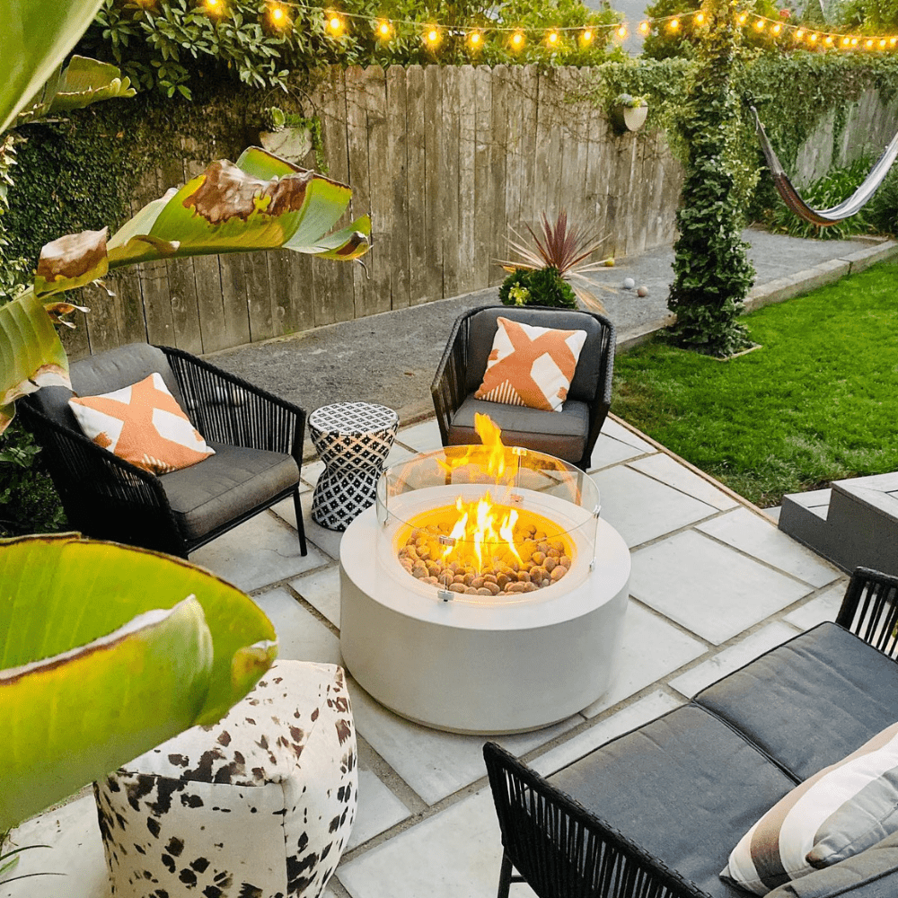 Modern Blaze Oblica Round Fire Pit in cozy patio seating area