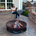 Woman Reading by Fire Pit