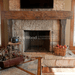 olde wood hand hewn wooden fireplace mantel below tv indoors