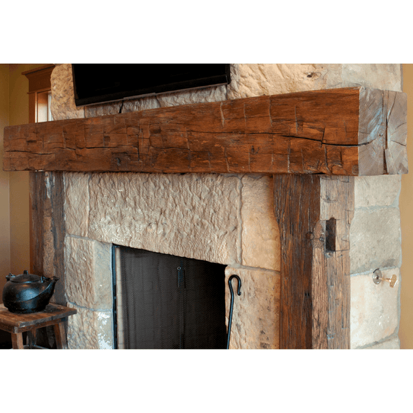 olde wood hand hewn wooden fireplace mantel on brick wall with tudor brown finish - close-up view