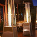 RADtec Tower Flame Stainless Steel Propane Patio Heaters lined up in a restaurant