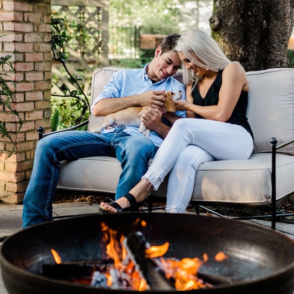sitting near the seasons fire pits elliptical round fire pit in a patio