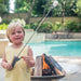 Seasons Fire Pits Concave Round Steel Fire Pit with Child Holding Marshmallow Stick