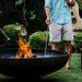 roasting marshmallows on the Seasons Fire Pits Vulcan Round Steel Fire Pit
