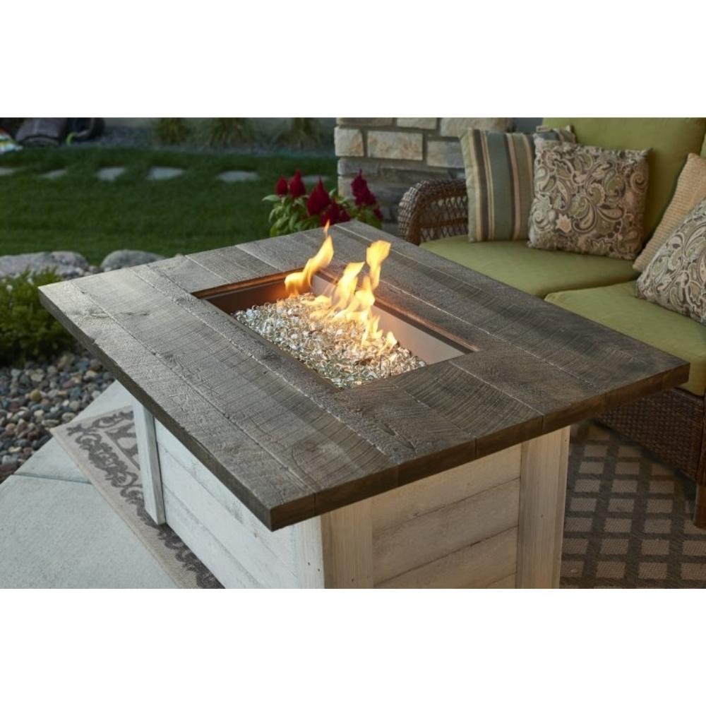 The Outdoor GreatRoom Company Alcott 48" Rectangular Gas Fire Pit Table in a Patio
