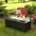 The Outdoor GreatRoom Company Balsam Montego 59" Fire Pit Table in Garden setting