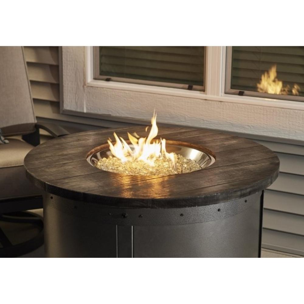 The Outdoor GreatRoom Company Edison 39-inch Round Gas Fire Pit Table lit up