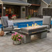 black uptown gas fire pit table by the pool in backyard
