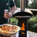 Cooking pizza in the Timber Stoves Pizza Hood for Big and 'Lil Pellet Patio Heater