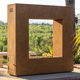 corten steel square outdoor gas fireplace in backyard