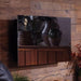 Touchstone Mirror Onyx Electric Fireplace mounted on a wall surrounded by decor