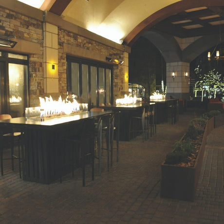 Warming Trends Linear CROSSFIRE™ Brass Burners in Outdoor Dining Area